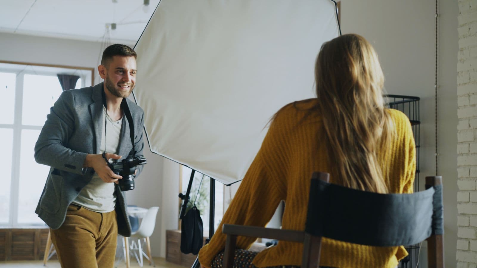 Rae directing a model beside a softbox, session in progress