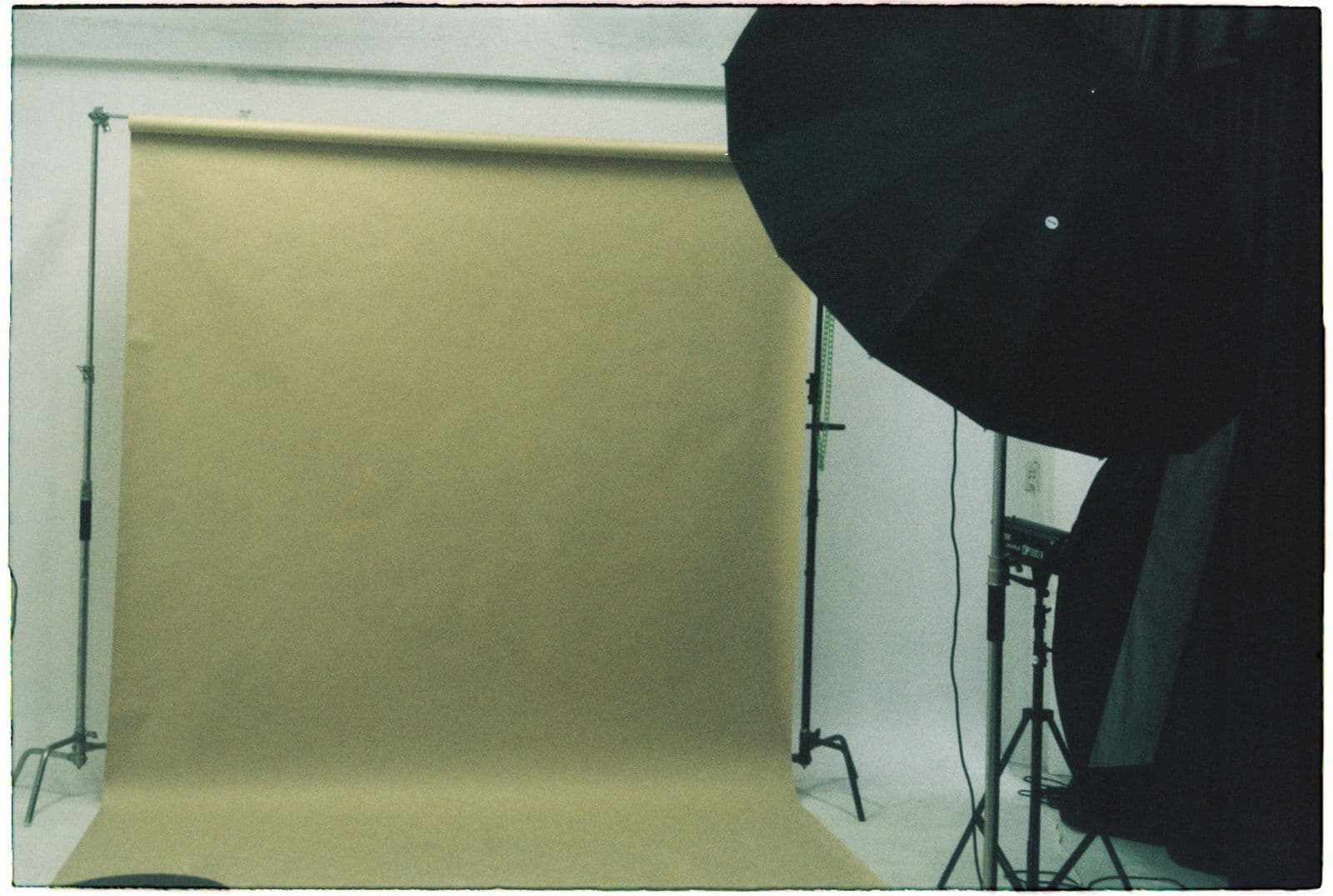 Seamless paper backdrop and parabolic umbrella on set between takes